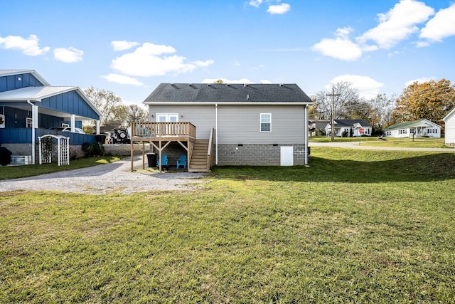 rear view of house with a wooden deck and a yard