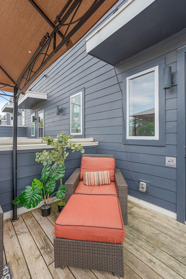 wooden terrace featuring an outdoor hangout area