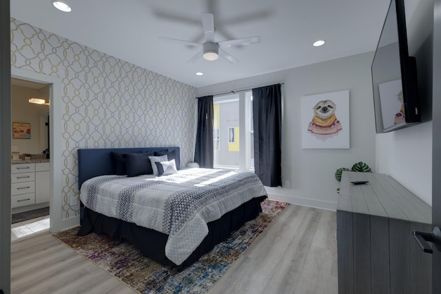 bedroom featuring ceiling fan, ensuite bathroom, and light wood-type flooring