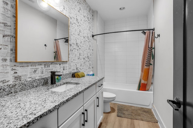 full bathroom featuring shower / bath combo with shower curtain, wood-type flooring, toilet, and vanity