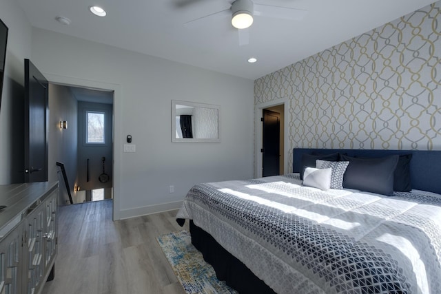bedroom with ceiling fan and light hardwood / wood-style flooring