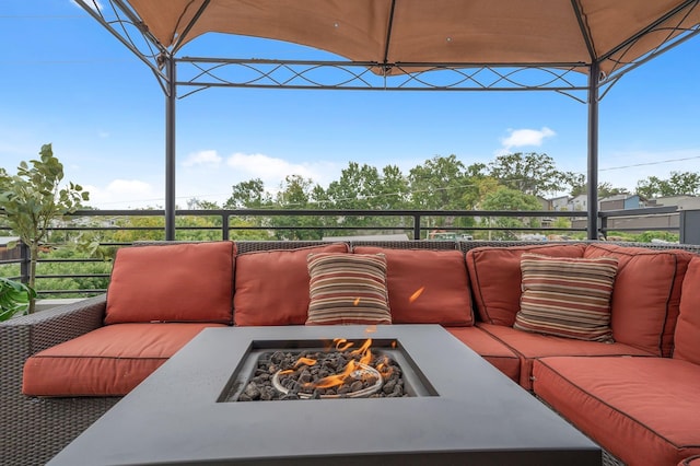 view of patio with an outdoor living space with a fire pit