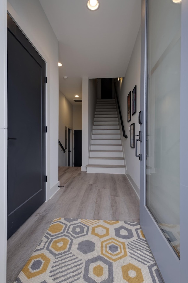 hallway with light hardwood / wood-style flooring