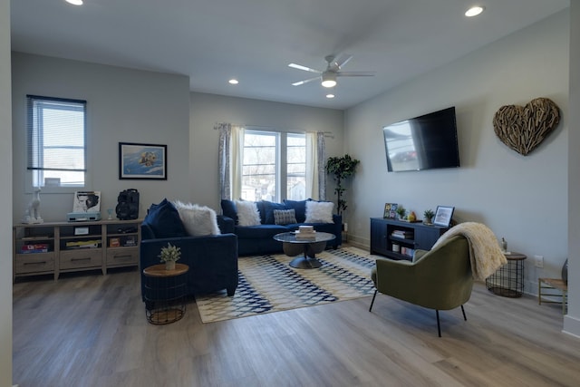living room featuring ceiling fan and hardwood / wood-style floors