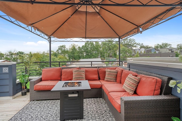 deck featuring a gazebo and an outdoor living space with a fire pit