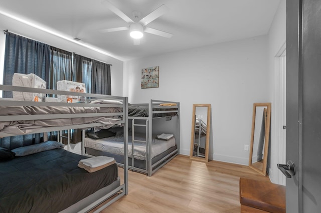bedroom with ceiling fan and light hardwood / wood-style flooring