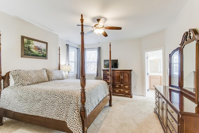 bedroom with light carpet, ceiling fan, and ensuite bathroom