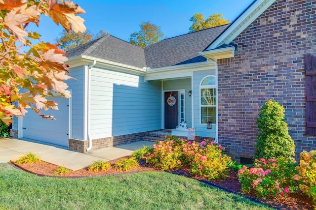 view of exterior entry with a garage