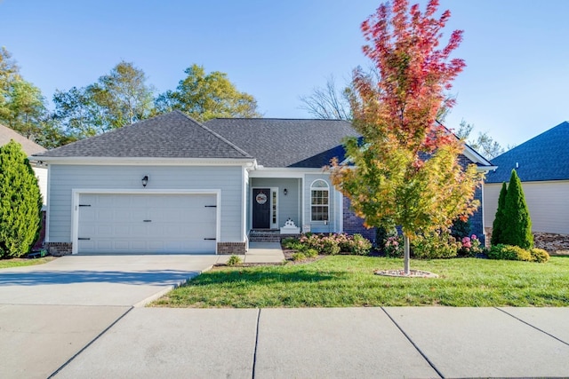 view of front facade with a front yard and a garage