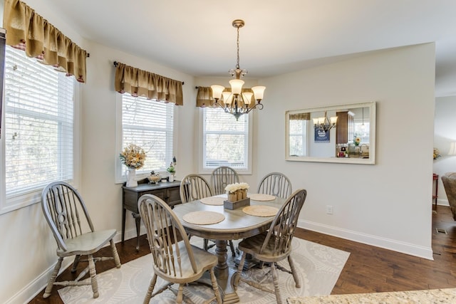 dining area featuring a notable chandelier and dark hardwood / wood-style flooring