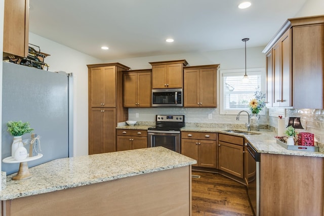 kitchen featuring dark wood-type flooring, sink, light stone counters, and stainless steel appliances