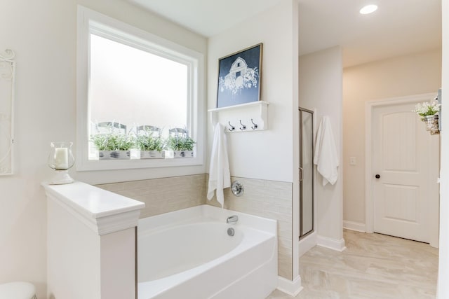 bathroom featuring independent shower and bath