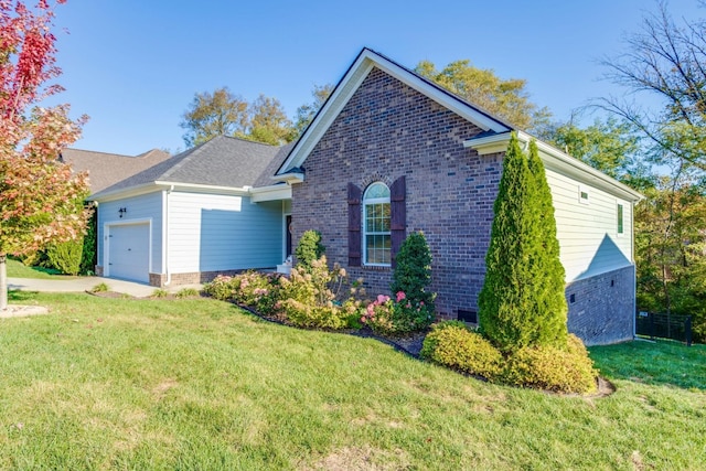 ranch-style house featuring a garage and a front lawn