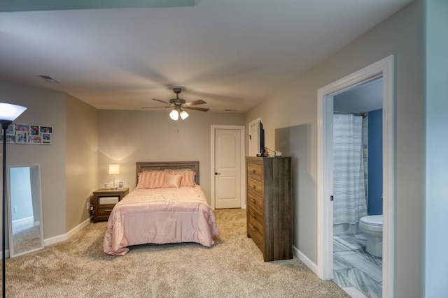 bedroom with ensuite bath, ceiling fan, and light carpet