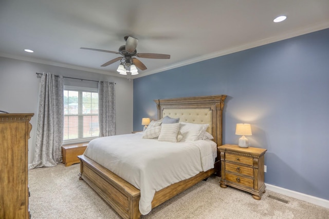 bedroom with ceiling fan, light colored carpet, and crown molding