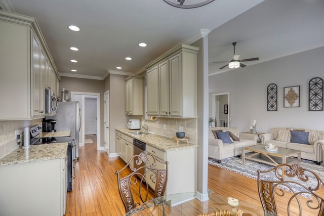 kitchen with ceiling fan, sink, backsplash, and appliances with stainless steel finishes