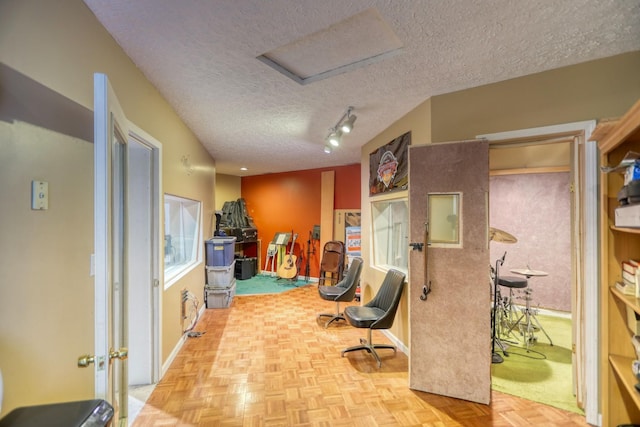 interior space with parquet floors and a textured ceiling