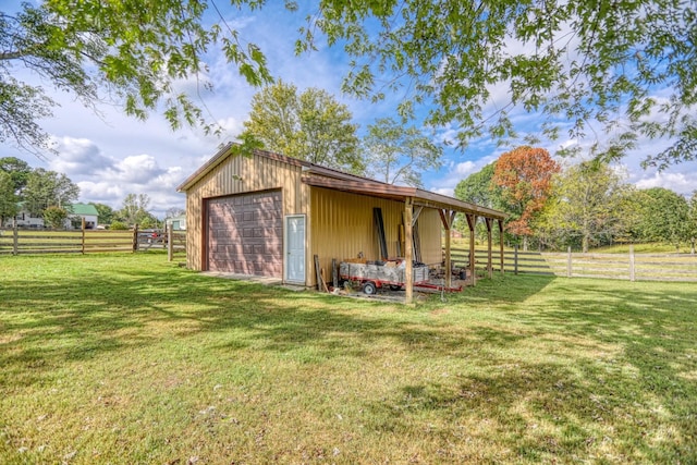 view of outdoor structure with a yard and a garage