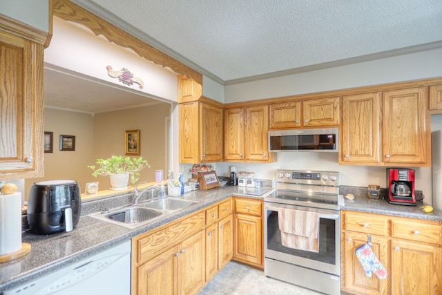 kitchen with sink, a textured ceiling, appliances with stainless steel finishes, and crown molding