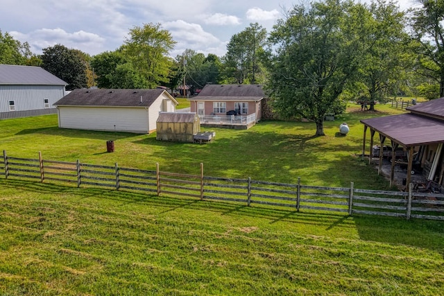 view of yard featuring a rural view and an outdoor structure