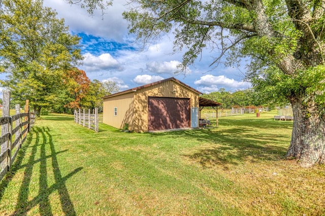 view of yard featuring a garage and an outdoor structure