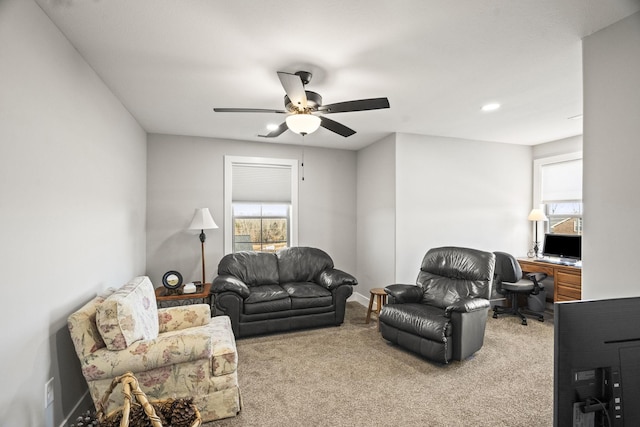 carpeted living room featuring ceiling fan