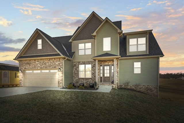 craftsman-style home featuring a garage and a lawn