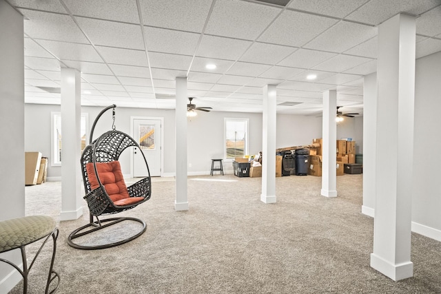 sitting room with ceiling fan, carpet, and a paneled ceiling