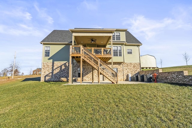 back of house featuring ceiling fan, a yard, and a wooden deck