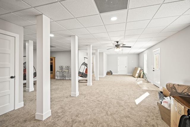 basement featuring ceiling fan and carpet