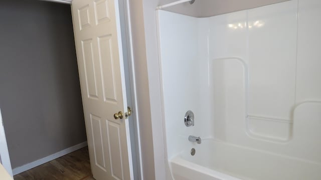 bathroom featuring shower / bathtub combination and wood-type flooring