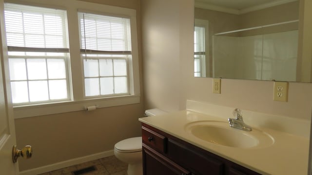 bathroom featuring toilet, vanity, tile patterned floors, a shower, and ornamental molding