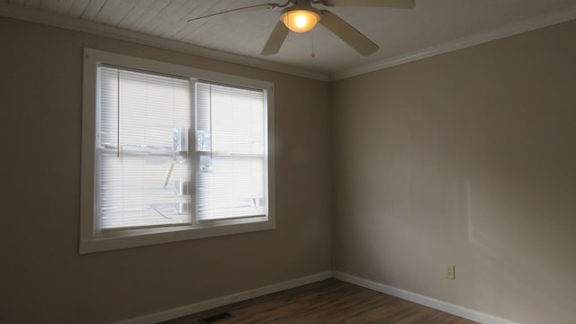 empty room with ceiling fan, dark hardwood / wood-style flooring, and crown molding