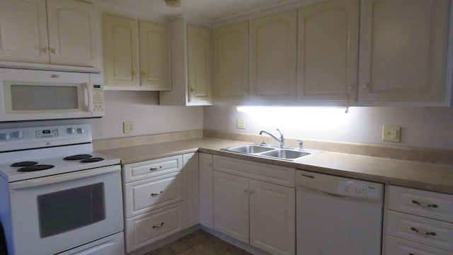 kitchen featuring light tile patterned floors, sink, and white appliances