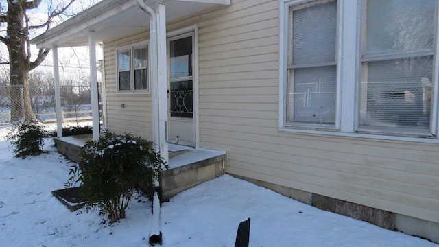 view of snow covered property entrance