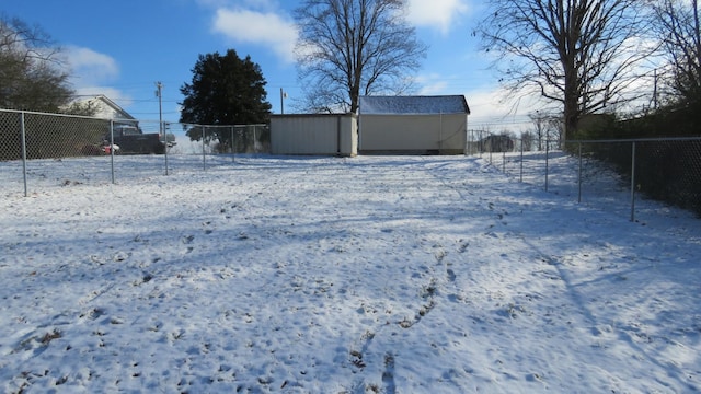 snowy yard with an outbuilding