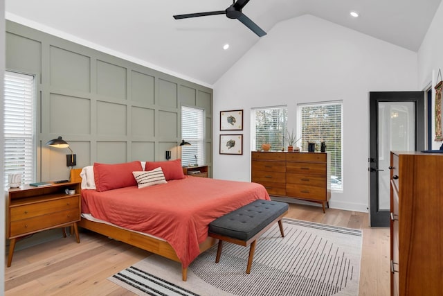 bedroom featuring ceiling fan, light hardwood / wood-style flooring, and high vaulted ceiling