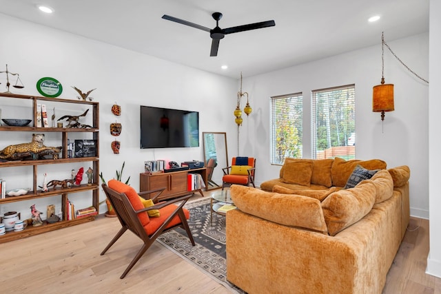 living room with ceiling fan and light hardwood / wood-style floors