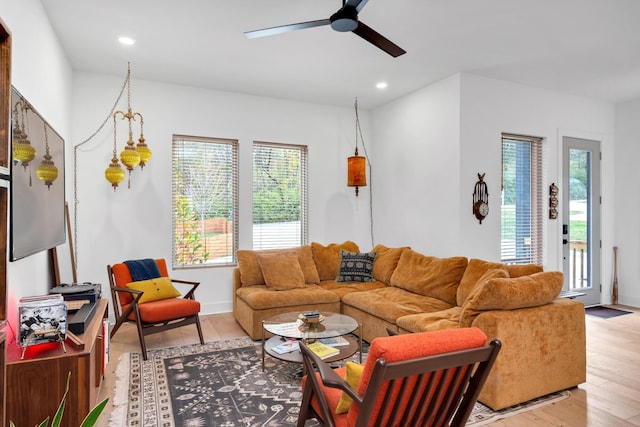 living room with ceiling fan and light hardwood / wood-style flooring