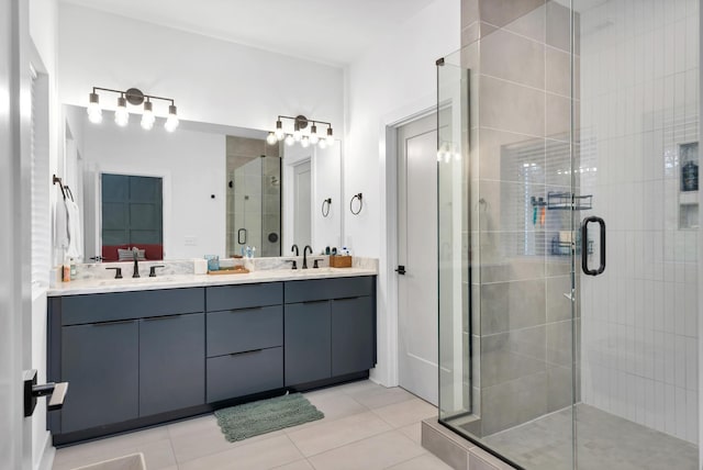 bathroom with a shower with shower door, tile patterned floors, and vanity