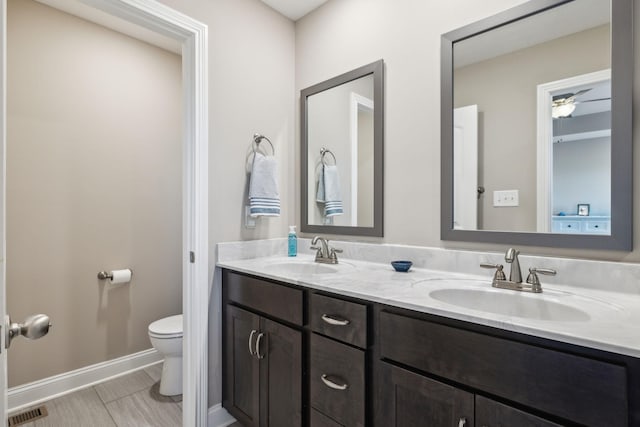 bathroom featuring toilet and vanity