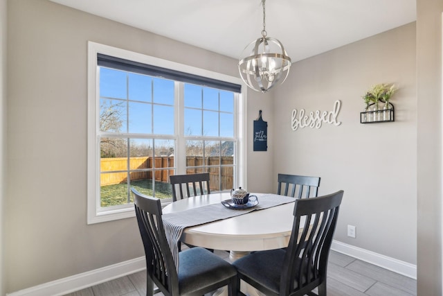 dining space with an inviting chandelier