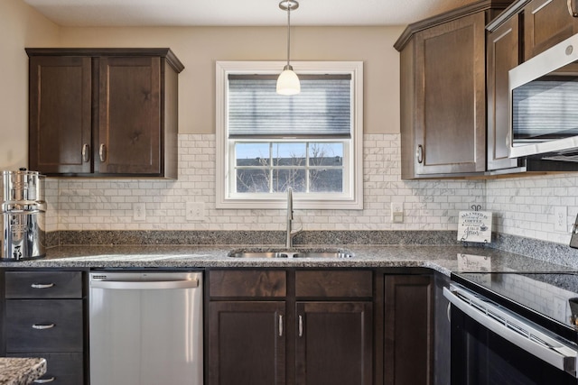 kitchen featuring sink, dark brown cabinets, hanging light fixtures, and appliances with stainless steel finishes