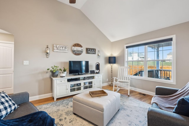 living room with light hardwood / wood-style floors and lofted ceiling