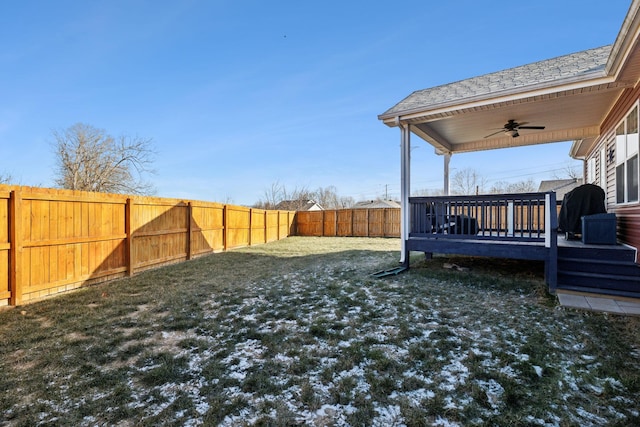 view of yard featuring ceiling fan and a deck