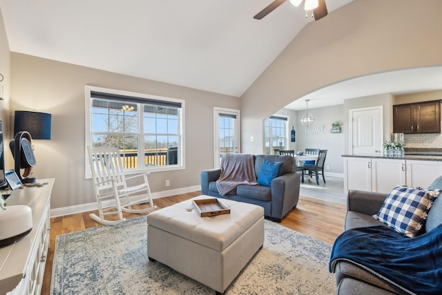 living room featuring light wood-type flooring, ceiling fan, and lofted ceiling