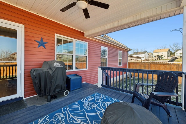 wooden terrace with ceiling fan and area for grilling