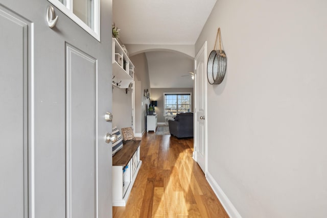 hallway with hardwood / wood-style flooring