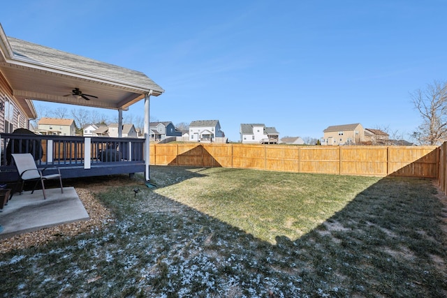 view of yard with a deck and ceiling fan