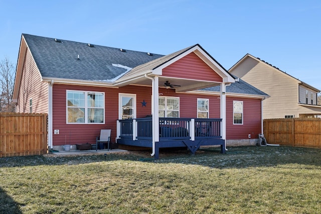 rear view of house featuring a yard, a deck, and ceiling fan